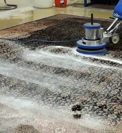 Professional rug cleaning with a rotary floor machine and shampoo foam, deep-cleaning an area rug Tulsa, OK.